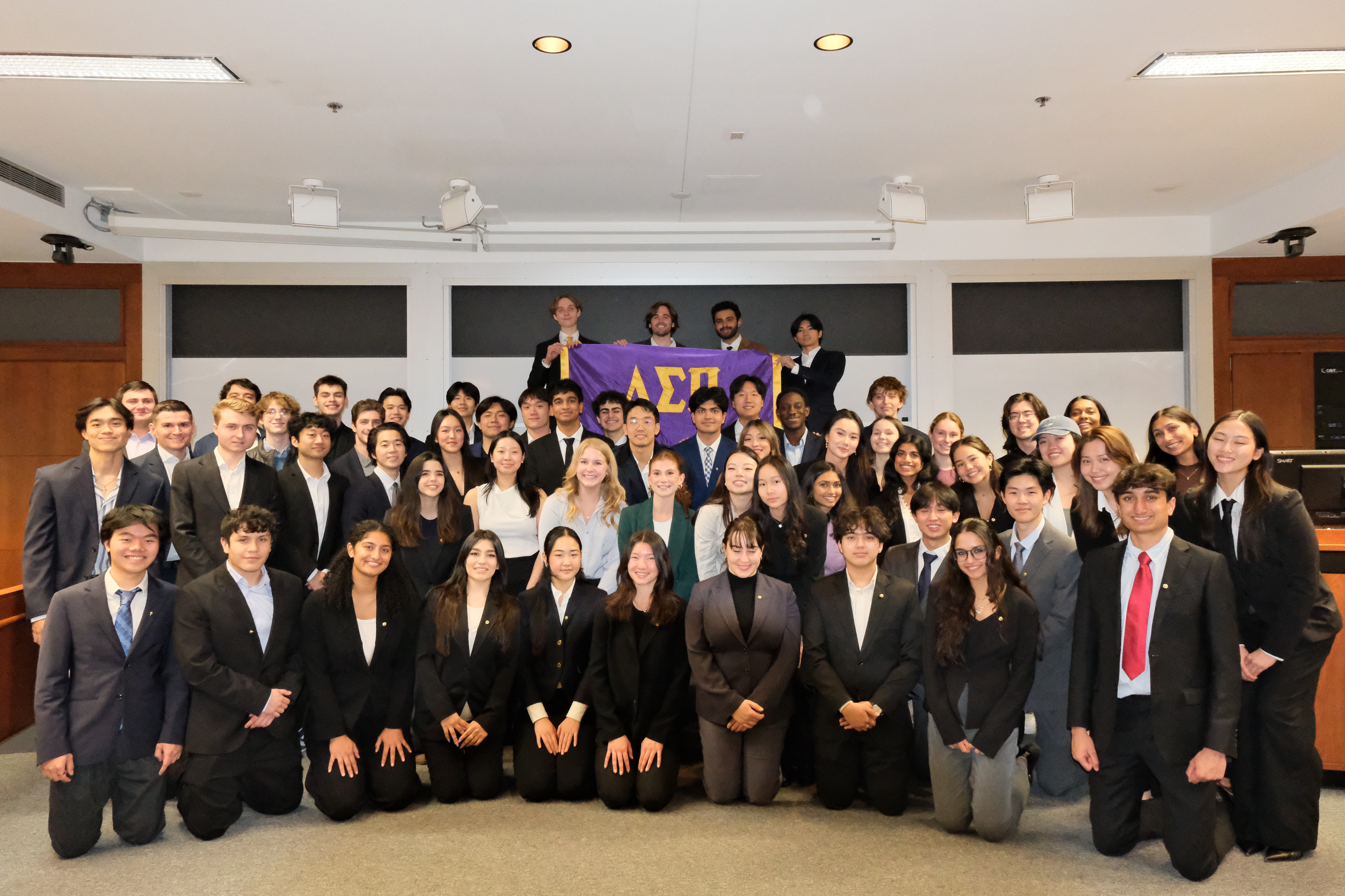 Students discussing a business case challenge during rush